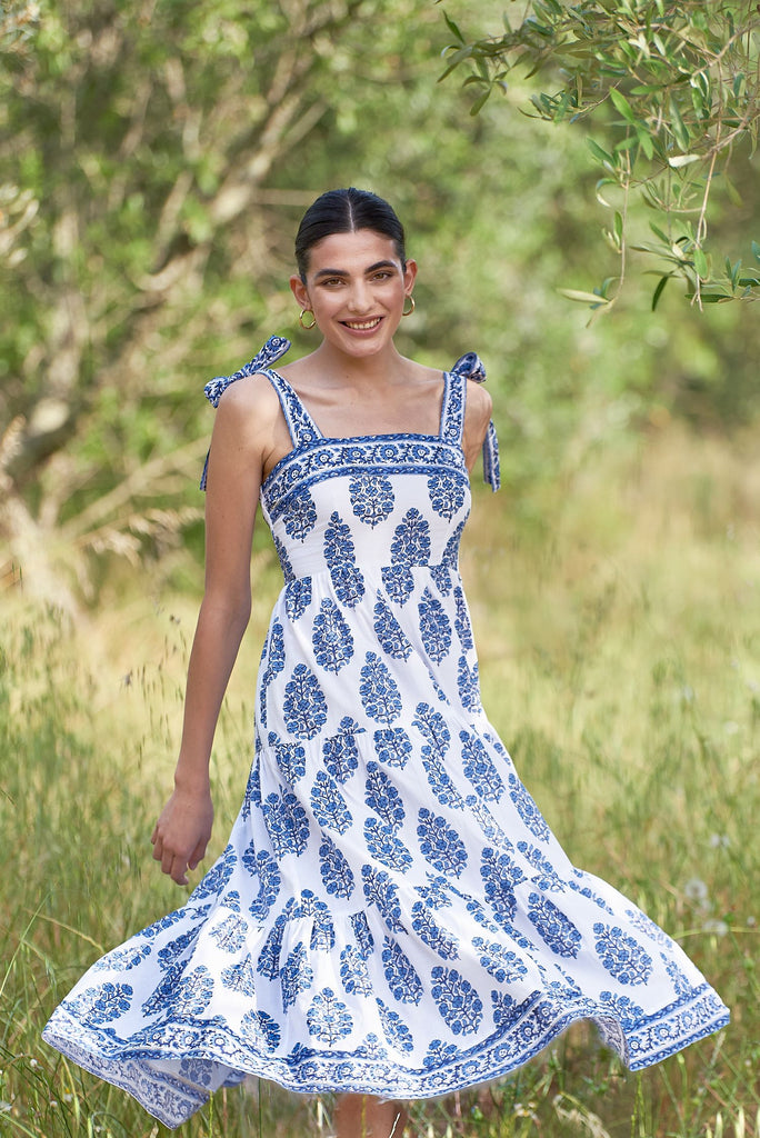 Blue pattern dress with woman smiling